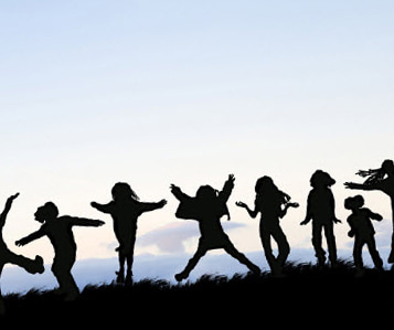 Kids silhouetted against the sky