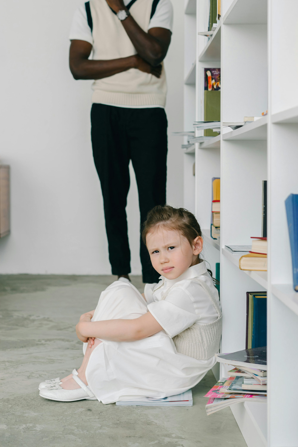 Obsessive Compulsive Disorder Therapy photo of a young girl leaning against a bookshelf