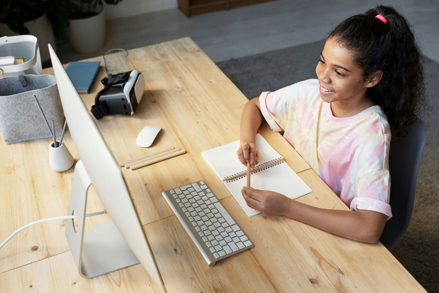Online therapy with Behaved Brain Wellness Center in New Jersey. Young teen girl joining a virtual therapy call on a computer.