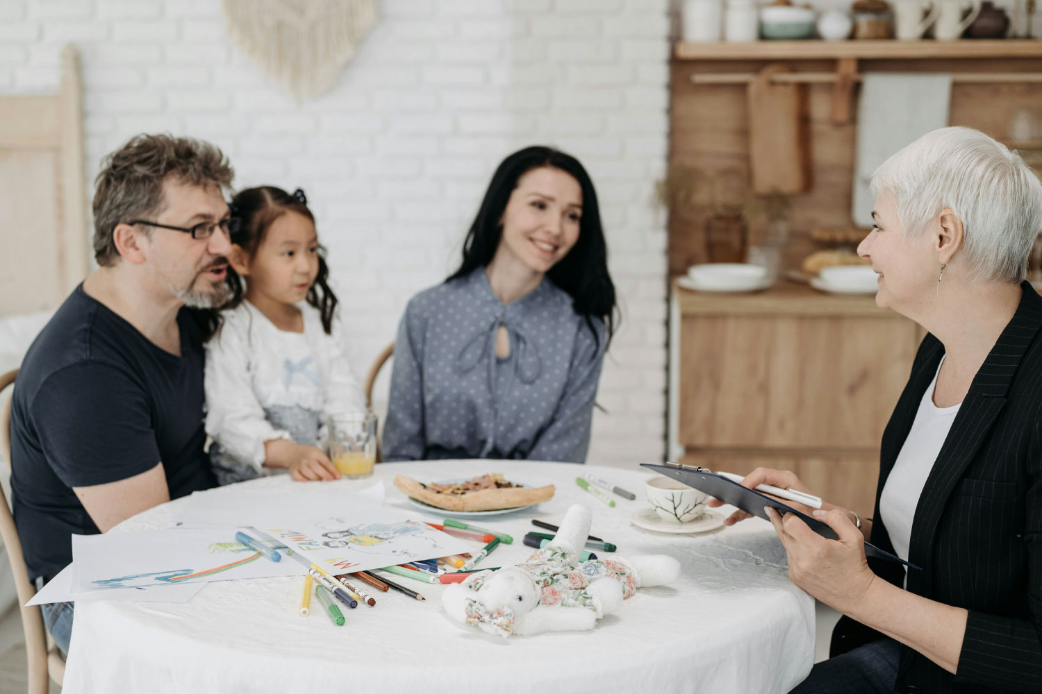 Divorce Therapy in Bergen County family sitting during a family therapy session with their young child