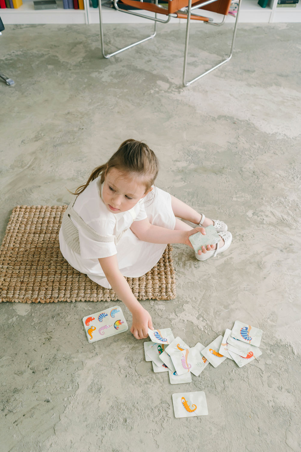 New Jersey Individual Therapy for children kids and teenagers young girl playing with therapy cards on a cement floor