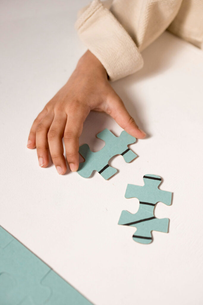 New Jersey Individual Therapy for children kids and teenagers small hand holding a puzzle piece