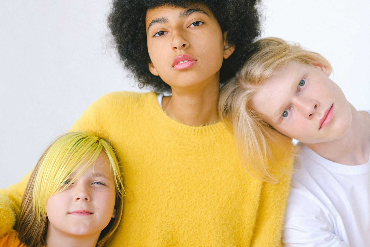 Parenting teens in 2025. 3 young boys pose for a photo of varying ages.