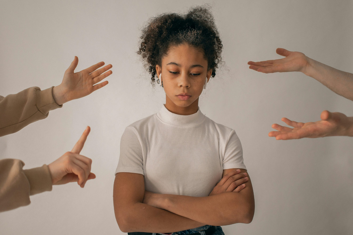 Discipline & Neurodivergent Kids. A teen girl stands with her hands crossed. Fingers are pointed in her direction.