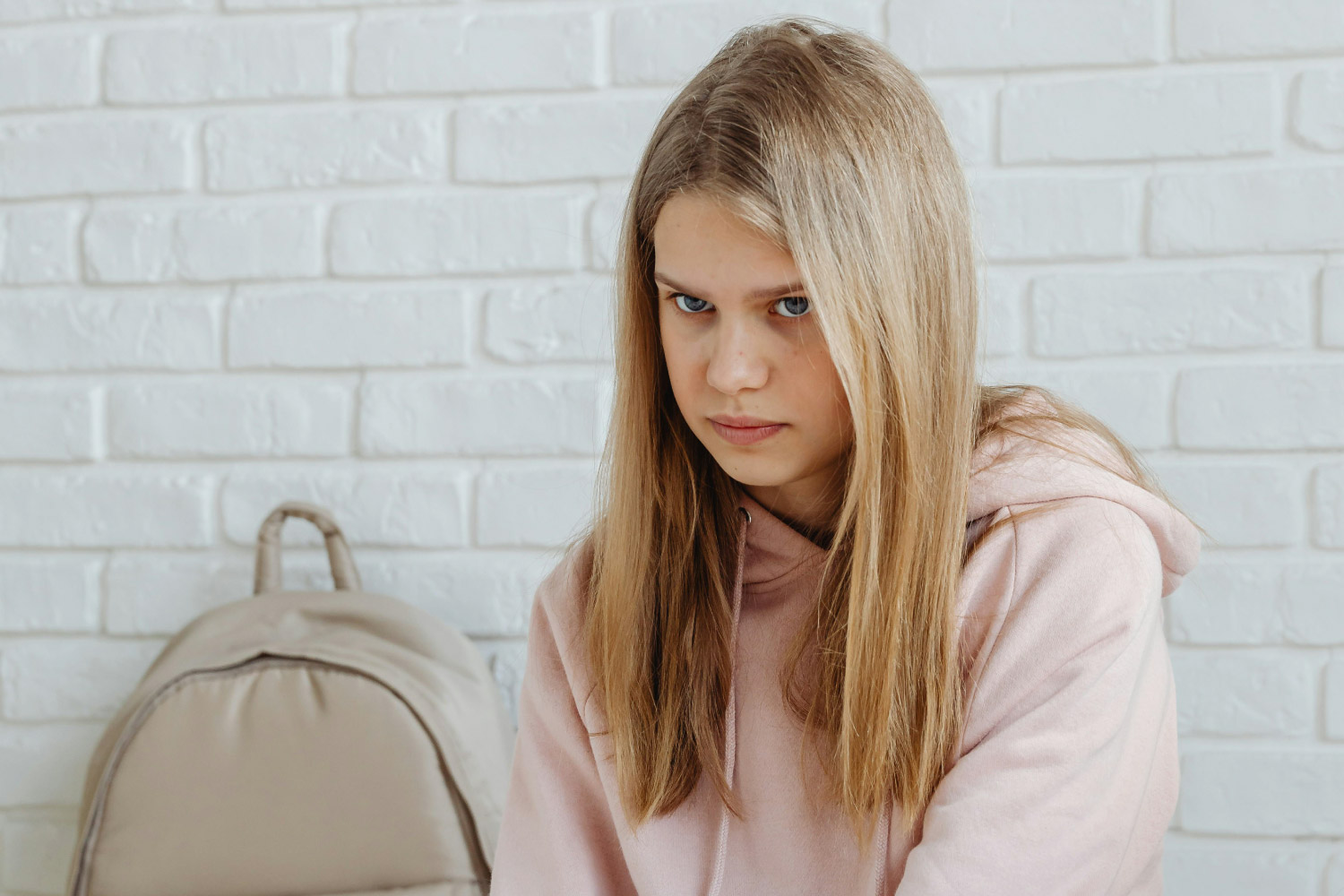 child avoiding stressful situation due to anxiety while parent offers support