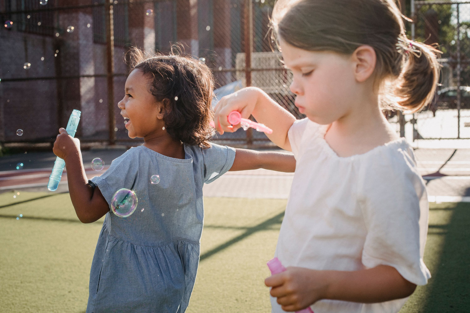 Children enjoying outdoor summer activities that support emotional wellness, physical activity, and healthy brain development.